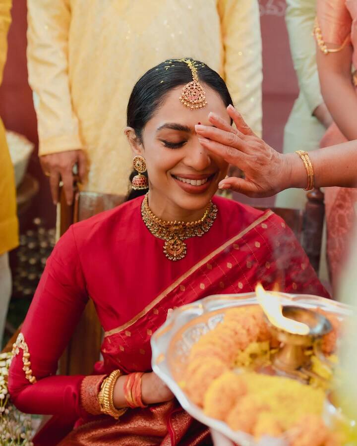 The photos capture her joy as she enjoys light-hearted moments with her family, including the ritual of turmeric paste being applied to her feet and an aarti being performed to signify her transition into a bride.