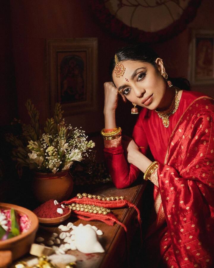 For the pelli kuturu ceremony, Sobhita looked radiant in a traditional red and gold saree, accessorized with the classic Telugu-style bottu adorning her forehead.