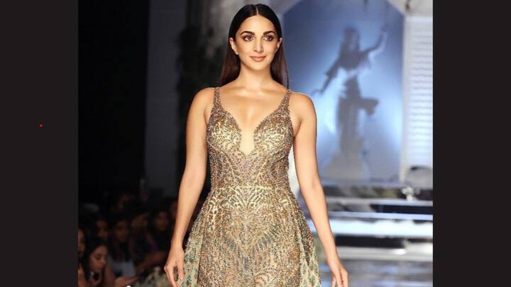Glittery Golden: With its plunging neckline and sheer beige train, covered with intricate sequins, that made an apparition into golden-green glittery gown, Kiara Advani made a grand wedding statement. The sleek hair and nude-toned makeup with smoky eyes added to her show-stopping allure. (Image source: Instagram/ kiaraaliaadvani)
