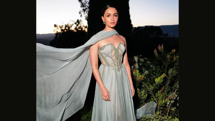 Powder Blue Stunner: For someone like Alia Bhatt, she draped herself in the most glorious strapless powder-blue gown that had a structured bodice accented with silver effects and sheer floor-length skirt. An additionally grey wrap-around neck brought in a regal touch to her pretty ensemble. (Image source: Instagram/ aliaabhatt)