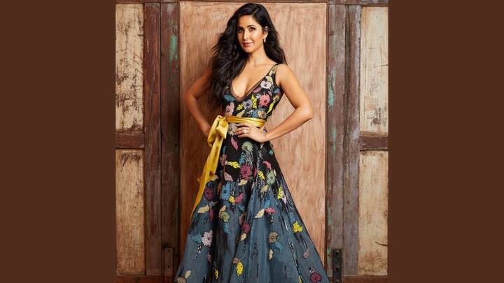 Floral Greenish Black Charm: Katrina Kaif looked absolutely stunning in a greenish-black gown that bore multicoloured floral details, a golden bow, and an edgy neckline. Minimalistic accessorisation, coupled with her natural yet flowy hair, epitomized a quintessential chic look for weddings. (Image source: Instagram/ katrinakaif)