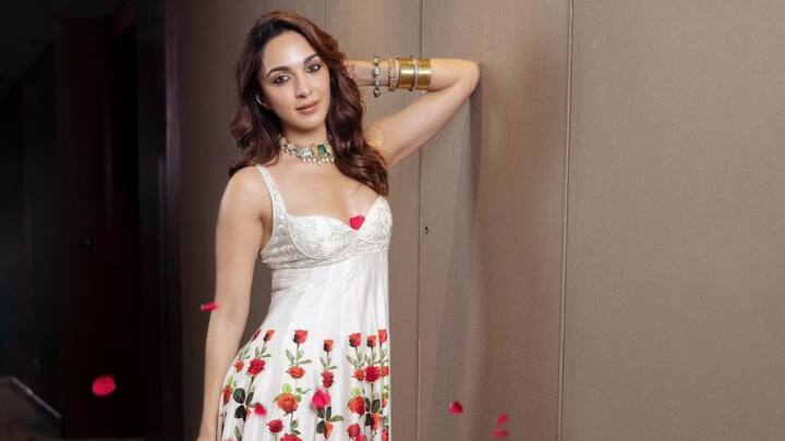 Kiara Advani in White Floral Gown: For a dreamy white outfit, opt for this delicate rose prints combined with lovely floral designs in a modern-shaped gown. The contrast between striking red rose motifs set against white background is bright enough to bring in that element of femininity, grace, and class-perfect for the chicest bachelorette gathering. (Image source: Instagram/ kiaraaliaadvani)