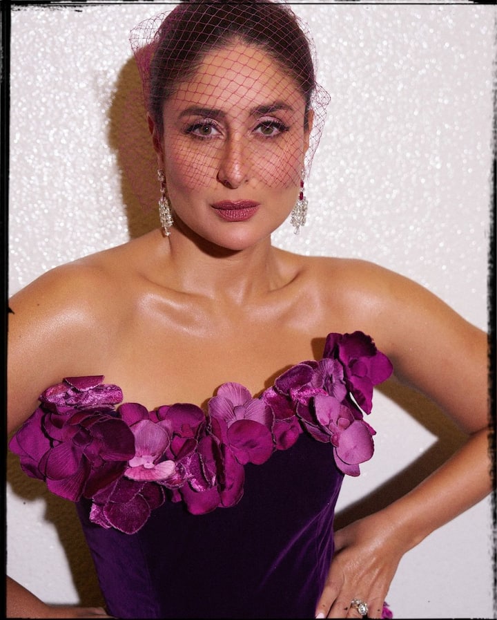 She paired the look with a sheer net headpiece that gracefully covered half of her face.