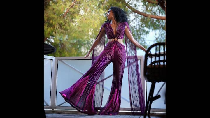 1. Sobhita Dhulipala: Sobhita's look features a shimmering violet jumpsuit that has intricate pleats and bold cutouts. The delicate cape that she has adorned adds a flowy touch to the outfit. The look is ideal for a glamorous party. (Image Source: Instagram/@sobhitad)