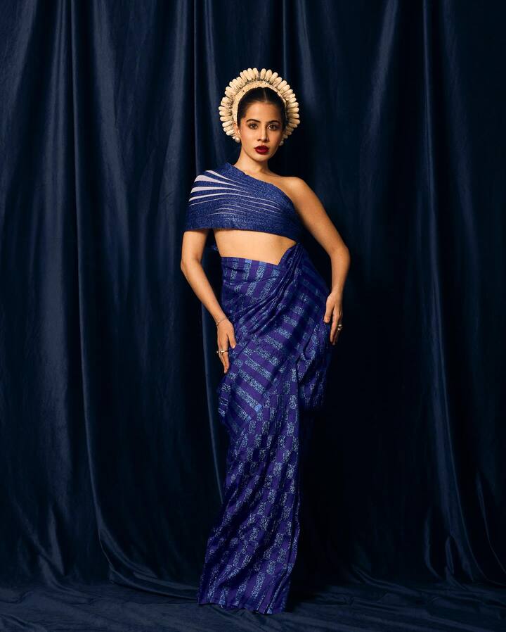 तिनेडार्क रेड लिपस्टिक लावली होती,  तिने तिचे केस एका अंबाड्यात गोलाकार केले होते. तिचा लूक पूर्ण करण्यासाठी उर्फीने ताहिया घातला.