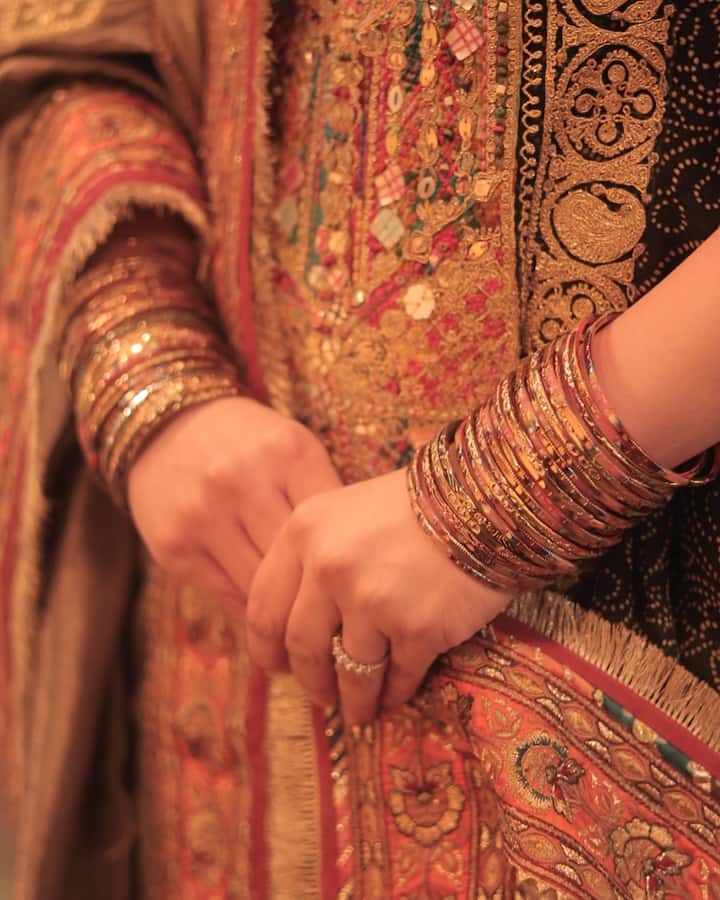 The green anarkali-style kurta features Bandhani work, scalloped borders, zardosi embroidery, gota patti work, and colorful threadwork.