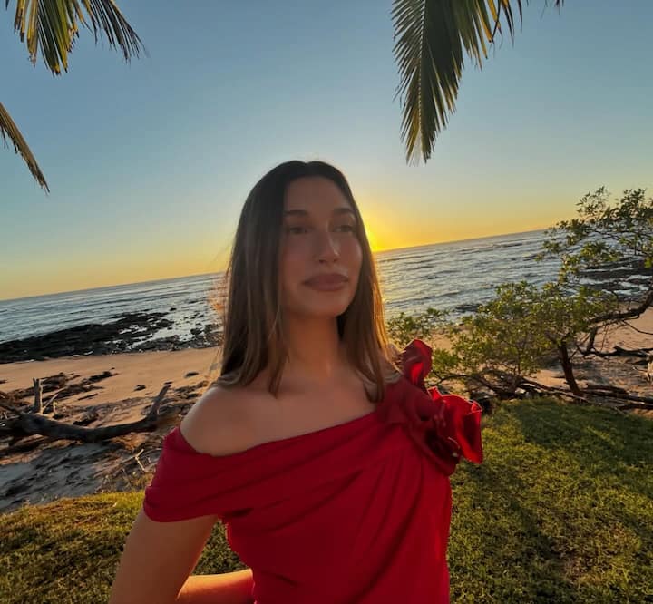 Another photo shows Hailey posing in a rose-emblazoned red dress.