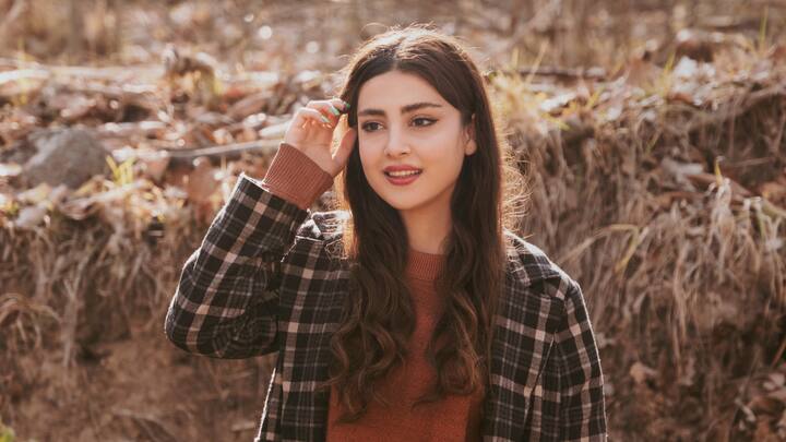 The Open-Air Christmas Party: For outdoor festivities, wear a plaid coat, wool scarf, and knee-high boots, with some holiday glitz on them. Tailored overcoats and festive sweaters teamed with leather boots, finished off by the beanie and gloves  sill look holiday-ready.  (Image source: Canva)