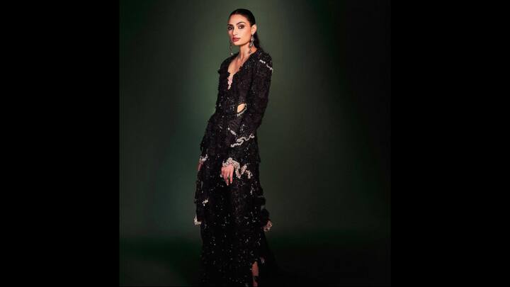 5. Athiya Shetty: Athiya Shetty wears a dazzling black gown with a flowing silhouette. The outfit gives her an edgy and glamorous look that's perfect for any New Year party look. The gown has beautiful artistic details which makes it unique. (Image Source: Instagram/@athiyashetty)