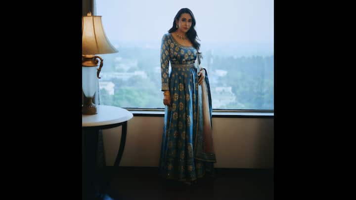 2. Karisma Kapoor: The blue and floor length anarkali with golden motifs worn by Karisma Kapoor seamlessly blends tradition and modernity. The intricate designs gives the actress a stunning look that's perfect for a festive gathering or celebration. (Image Source: Instagram/@therealkarismakapoor)
