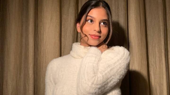 To keep it dynamic, Suhana Khan opted for a snug white turtleneck, crop-top-style sweater, and added to the comfort a matching midi skirt. This glossy lip look with pink lips was crowned by center-parting a loose ponytail with side fringes, exuding effortless charm. (Image source: Instagram/ suhanakhan2)