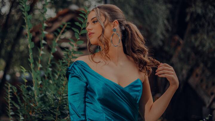 Satin Dress: A body-fitted halter satin dress that flatters your figure beautifully, this option is perfect for making a lasting impression at any New Year's Eve party. Its vibrant colors ensure you stand out in the crowd. (Image Source: Canva)