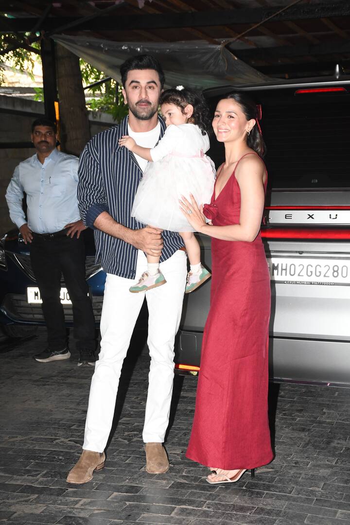 Alia was radiant in a red satin dress, her hair styled with a matching bow that added a festive touch.