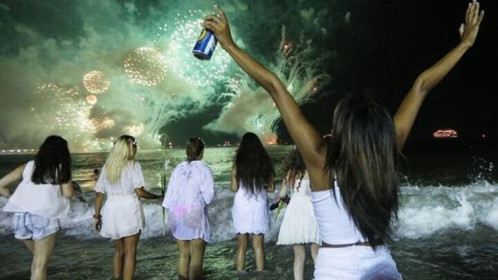 6. Jumping Seven Waves: People wear white on New Year's Eve in Brazil which signifies peace and renewal. They head to the beach and jump over seven waves, each representing a wish or request to a different deity for blessing. (Image Source: Pinterest/writeroperator)