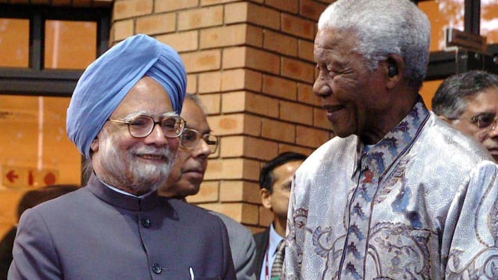Former South African President Nelson Mandela with Prime Minister Manmohan Singh at a function in Johannesburg on October 2, 2006.