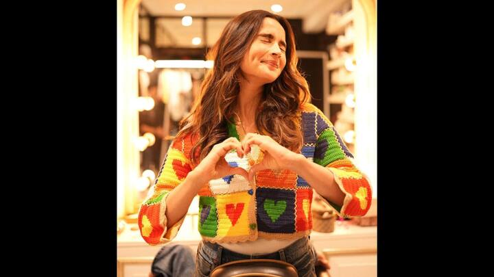 7. Alia Bhatt: Alia Bhatt looks charming in a stunning crochet sweater that has heart patterns all over it. The vibrant multicoloured sweater adds a casual yet chic touch and radiates playful energy and style. (Image Source: Instagram/@aliaabhatt)