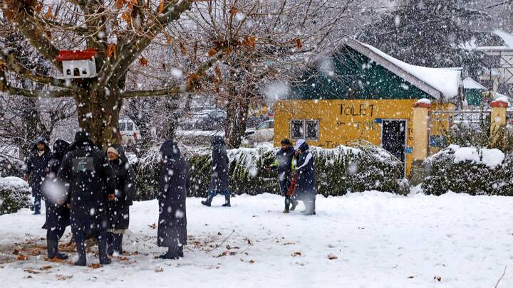 Visitors at a lawn amid fresh snowfall at Tangmarg area, in Baramulla district, Jammu and Kashmir. Snowfall was witnessed in several areas of Bandipora, Baramulla and Kupwara districts in north Kashmir and some parts of Budgam and Ganderbal districts in central Kashmir.  (Photo:PTI)