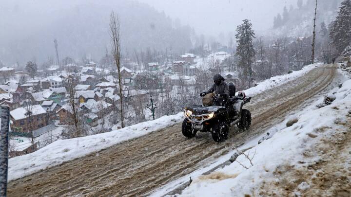 A commuter rides an ATV motorbike amid fresh snowfall at Tangmarg area, in Baramulla district. Kashmir is currently under the grip of 'Chillai-Kalan' -- the harshest period of winter -- that began on December 21. (Photo:PTI)