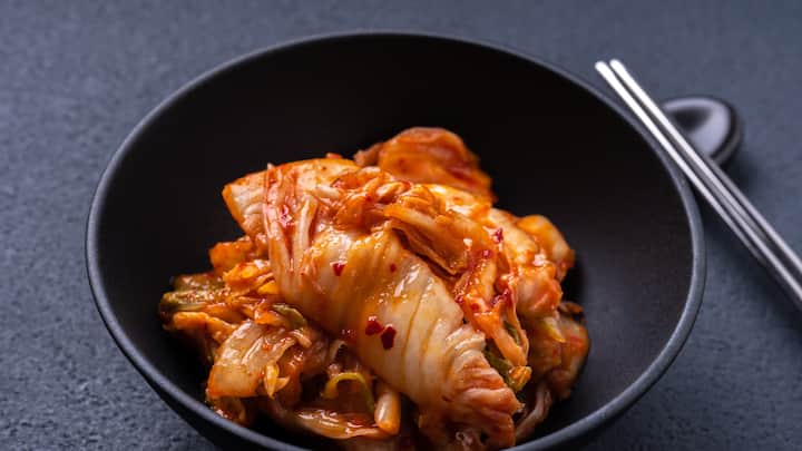 4. Kimchi Momos: These momos contain a Korean fermented vegetable dish known as kimchi, which makes it a bit spicy. The dipping sauce and momo mix gives a burst on the taste buds with every bite when eaten together. These are ideal for those with a taste for intense, pickled foods.  (Image Source: Canva)