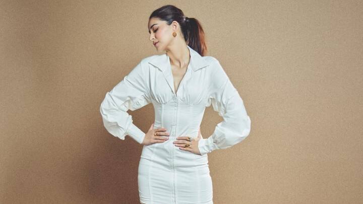 Ananya looked glamorous in a form-fitting white dress with a front hook and supported boning that showcased her figure. The oversized sleeves created a dramatic touch that went well with minimal accessories and a chic ponytail to add glam to the outfit. What a beautiful evening look this is. (Image source: Instagram/ ananyapanday)