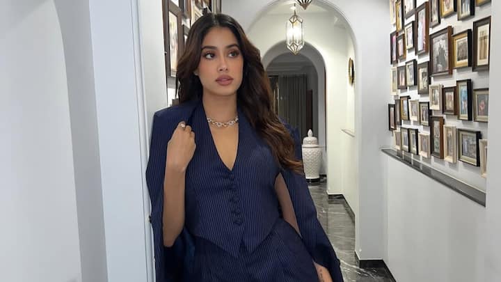 Janhvi slayed it in a set of pinstriped pants, coupled with a cropped-waisted, plunging V-back waistcoat, thereby conclusively redefining elegance. Its asymmetric hem with a halter neck became the loudest scream for modernity and made the entire ensemble a perfect pick for classy soirees like weddings and receptions. (Image source: Instagram/ janhvikapoor)