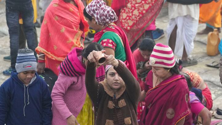 Devotees pray on the river bank, on the first day of Maha Kumbh Mela 2025, in Prayagraj, Uttar Pradesh, Monday, Jan. 13, 2025.