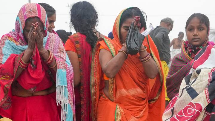 Devotees pray as they take a holy dip in the Ganga river on the first day of Maha Kumbh Mela 2025, in Prayagraj, Uttar Pradesh, Monday, Jan. 13, 2025.