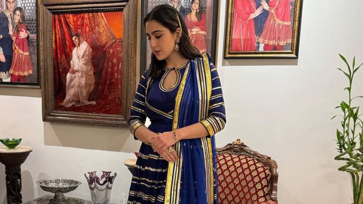 Sara steals the spotlight in a royal blue Anarkali suit ornamented with gold gota patti work. The kurta was backless with super adorable dori ties. She kept the dupatta light, with tassels at the edge; juttis completed the desi girl vibe with half-tied hair and large gold jhumkas. (Image Source: Instagram/ saraalikhan95)