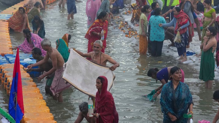 Devotees take a holy dip on the first day of Maha Kumbh Mela 2025, in Prayagraj, Uttar Pradesh, Monday, Jan. 13, 2025.
