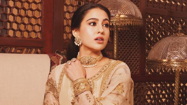 Sara Ali Khan dazzled in an ivory and gold Anarkali set, her outfit featured a pure organza pishwas with intricate marori work, heavy zardozi, and traditional embellishments. She completes her royal look with minimal accessories, exuding timeless ethnic charm. (Image Source: Instagram/ saraalikhan95)