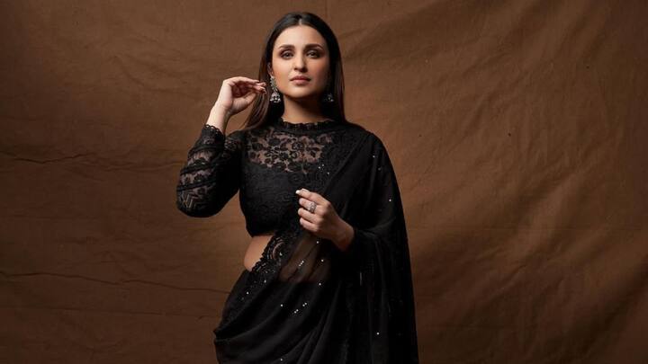 Parineeti Chopra stunned in a black lace saree with silver sequins and intricate lace borders. She paired it with a full-sleeved blouse featuring ruffled details at the neckline. Oxidised earrings and smokey eyes added a dramatic yet elegant finish. (Image Source: Instagram/ parineetichopra)