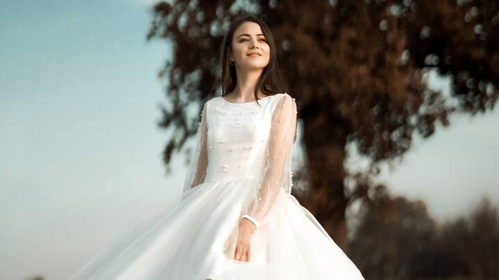 Flared Dress: Flared dresses are full of playfulness as they have the flowing, voluminous skirts. From tiered to gathered, these dresses can be perfect for brunch or any event that deserves a twirl-worthy outfit. (Image Source: Canva)