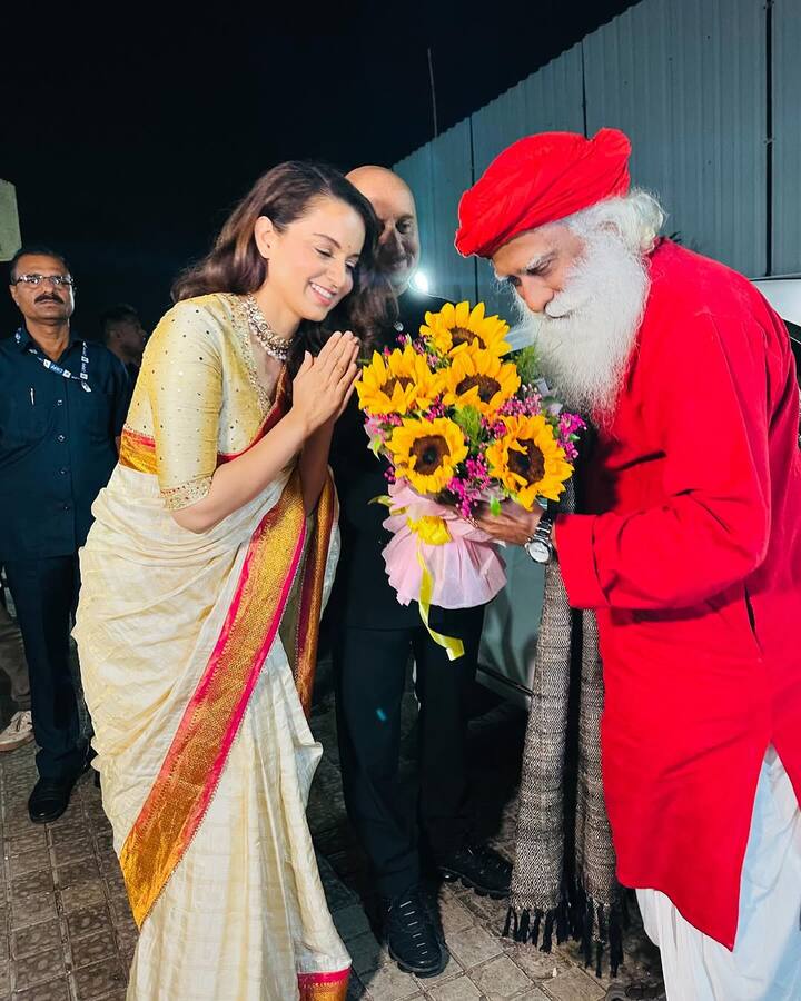 Kangana looked elegant in a golden-beige saree. Sadhguru was seen in a red attire and Anupam Kher was also present with them.