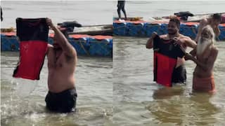 rcb fan dip team jersey in maha kumbh before ipl 2025 watch video royal