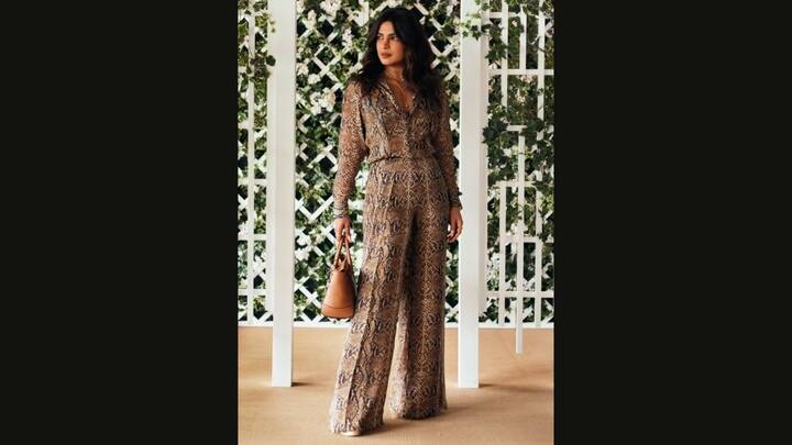 1. Priyanka Chopra: Priyanka Chopra looked stunning in an earthy snakeskin print co ord set. Her outfit featured a flared silhouette. She paired her outfit with a tan handbag, gold jewellery, and rust toned accents which gave her a chic look. (Image Source: Twitter/@AboutHerOFCL)