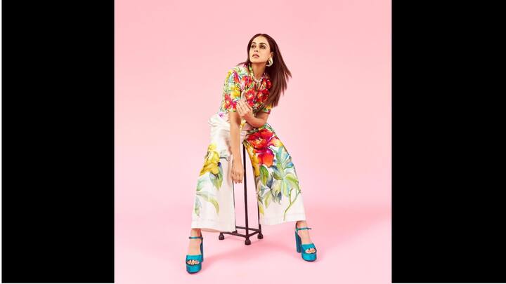 8. Genelia D'Souza: Genelia D'Souza looked vibrant in a floral co ord set. Her outfit featured huge multicoloured floral prints on a white back. She completed her look with a statement pearl necklace and high blue heels. (Image Source: Instagram/@geneliad)