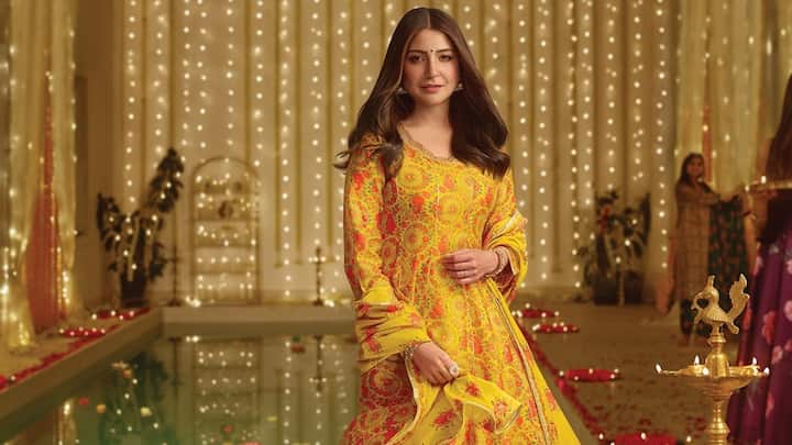 Aushka Sharma chose a breezy yellow kurta with palazzo pants, highlighted by a pink floral print. This outfit exudes elegance and is ideal for a festive yet understated look. (Image Source: Instagram/ wforwoman)