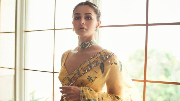 Alia was elegant in a yellow saree with delicate floral embroidery, complemented by a sleeveless matching blouse. Her neatly braided hair and subtle jewellery, including a necklace and earrings, added a refined touch to her graceful look. (Image Source: Instagram/ aliaabhatt)
