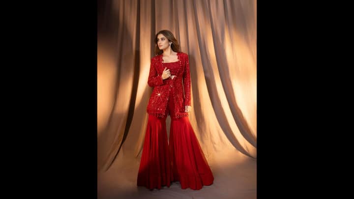 4. Three Piece Sharara Set: Rasha Thadani stunned everyone in a bold red three piece sharara set that exuded grace and charm. Her outfit featured a heavily embellished bralette and a matching jacket, both intricately adorned with mirror work. She balanced her fit with a simple and flowy sharara pants to add an effortless elegance to her look. (Image Source: Instagram/@rashathadani)