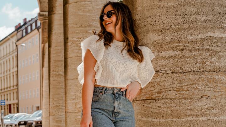 A trendy crop top paired with well-fitted jeans strikes the perfect balance between casual and chic. Opt for a pastel or red-toned top to embrace the valentine's vibe, and complete the look with heels or dainty accessories. (Image Source: Canva)
