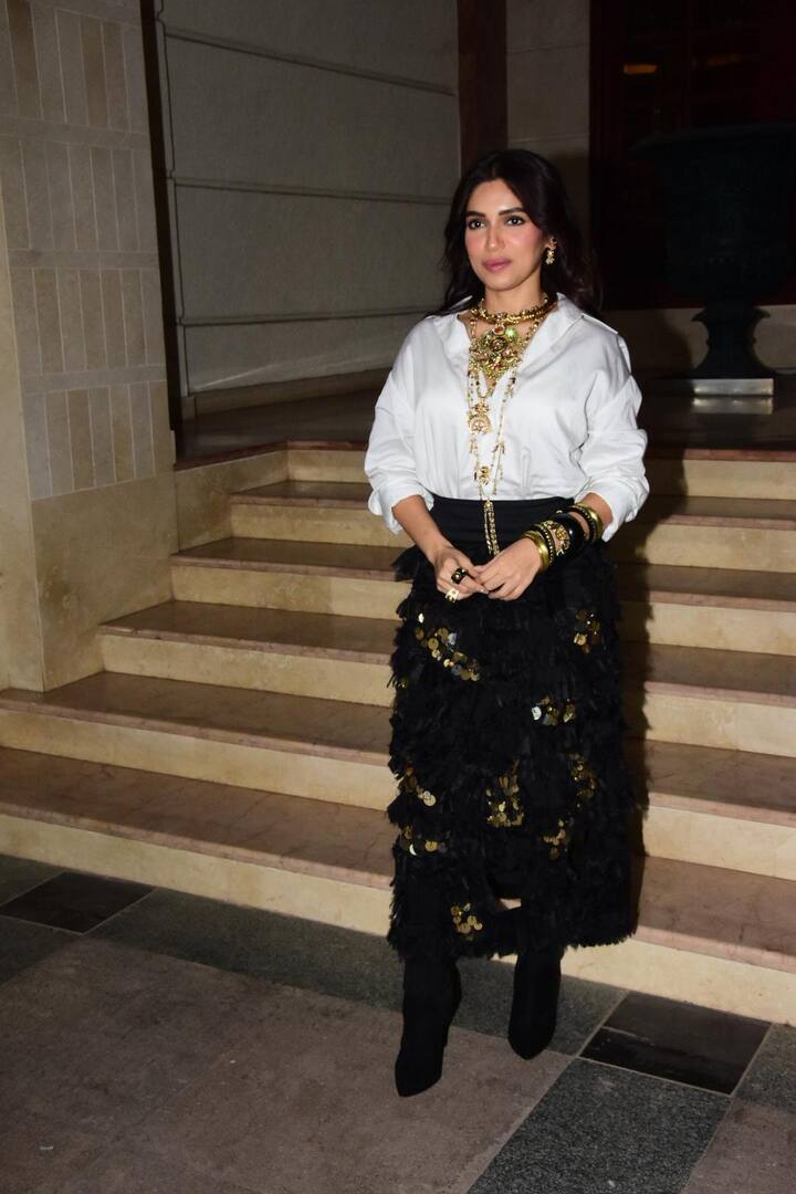Bhumi Pednekar opted for a white shirt paired with an embellished black skirt. She elevated her look with stackable accessories and black boots.