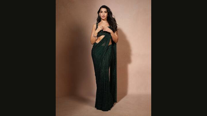 3. Emerald Green Saree: Nora looked beautiful in a shimmering emerald green pre draped saree which exuded elegance. She paired her saree with a heavily embellished blouse. She completed her traditional look with exquisite diamond studded jewellery. (Image Source: Instagram/@norafatehi)