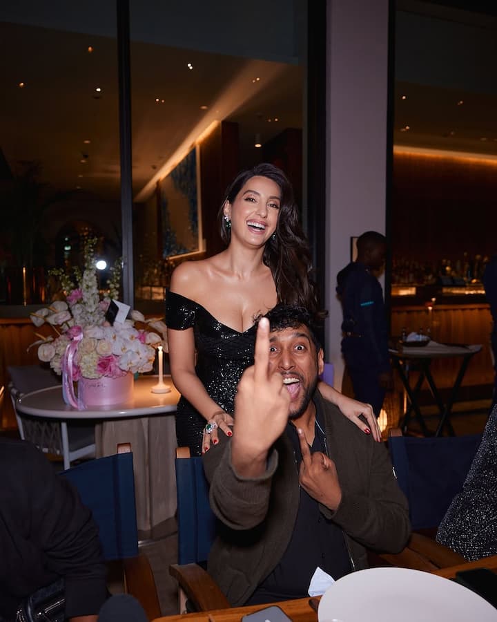 Nora stunned in a shimmery off-shoulder dress with a thigh-high slit for the occasion.