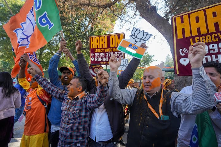 BJP supporters celebrate the party's lead in the Delhi Assembly polls as the counting of votes is underway, outside the party office in New Delhi, Saturday, Feb. 8, 2025. (Image Source: PTI)