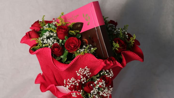 1. Flower Bouquet: Fresh flowers are a wonderful way to express your love, whether they are classic red roses or a bouquet of vibrant blooms. Gifting flowers defines much love, romance, and soft emotions. (Image Source: Canva)
