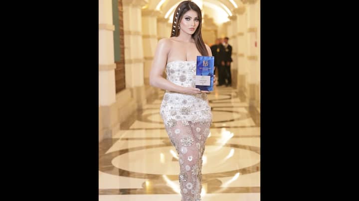 6. Operated white dress: Urvashi was shocked in an angelic white dress, which removes the grace. The delicate detailing and minimum accessories exposed the beauty of the actress. Her dress gave her a dream and modern look. (Image Source: Instagram/@urvashirautela)