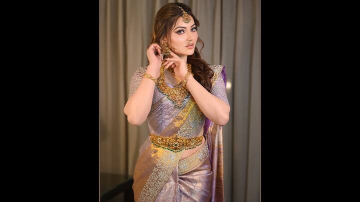 She complemented her dress with a heavy embroidered blouse. She completed her look with ornate Golden Jewelery, which exposed elegance and glow. (Image Source: Instagram/@urvashirautela)