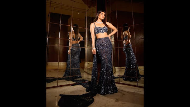 8. Navy Blue Sequined Look: Priyanka wore a bold navy blue sequined lehenga that embraced contemporary fashion. Her shimmering look featured a fitted long skirt and an embellished bralette. She paired her chic traditional look with diamond jewellery that made her look elegant. (Image Source: Instagram/@priyankachopra)