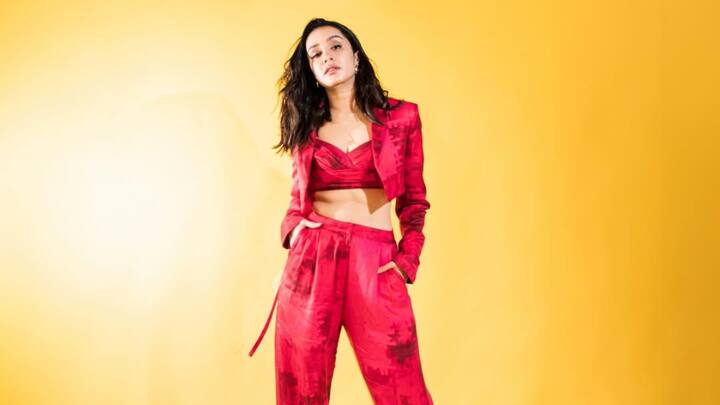 Shraddha Kapoor slays in an abstract red-toned three-piece pantsuit, featuring high-waisted pleated trousers, a V-neck bralette, and a cropped blazer. A bold, sophisticated choice for a chic Valentine's Day dinner. (Image Source: Instagram/ shraddhakapoor)