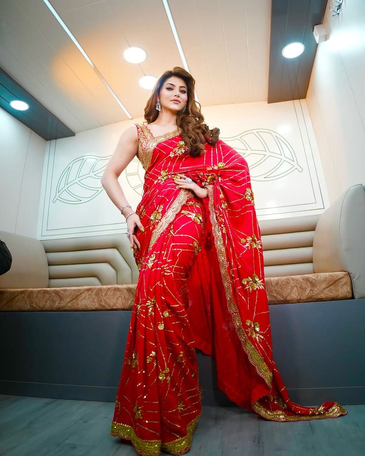 Urvashi's vibrant red saree was adorned with intricate gold floral embroidery, exuding a timeless charm.